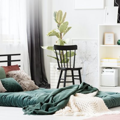 Green mattress in bedroom interior